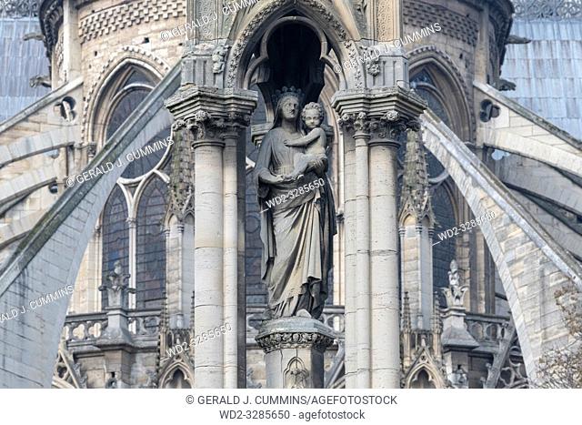 Statue of Mother Mary holding baby Jesus outside the Notre Dame Cathedral in Paris, France