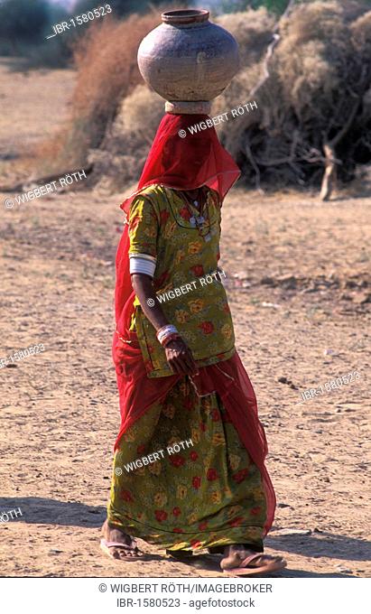 Young woman in sari with water jug, Thar Desert, Rajasthan, India, Asia