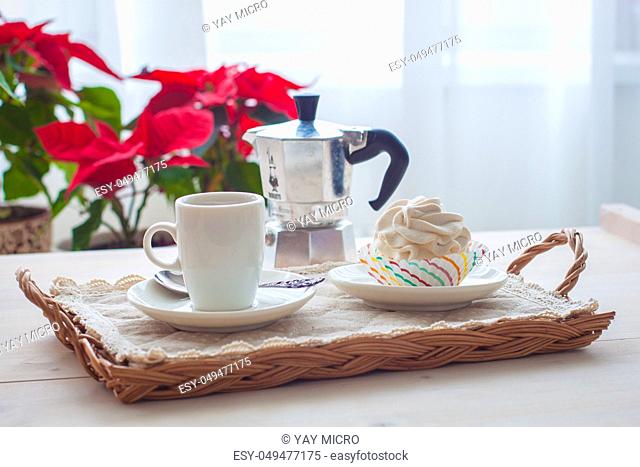 Breakfast wit marshmallow or zephyr with a cup of coffee near Christmas poinsettia. Toned