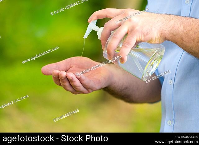 Man hands using wash hand alcohol gel or sanitizer bottle dispenser, against coronavirus disease Covid-19 . Antiseptic, Hygiene and Health concept