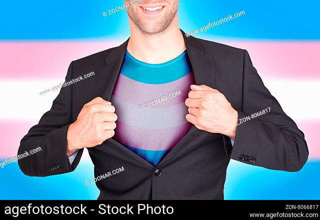 Businessman opening suit to reveal shirt with flag, Trans Pride