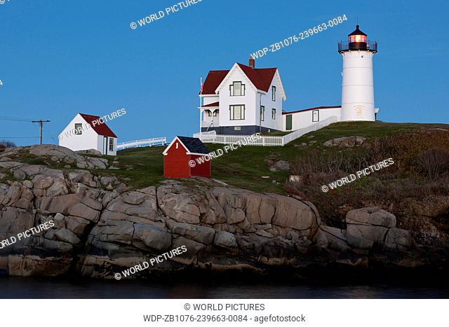 Cape Neddick Lighthouse (also known as Nubble Light) at twilight; York Beach, Maine