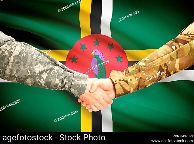 Soldiers shaking hands with flag on background - Dominica