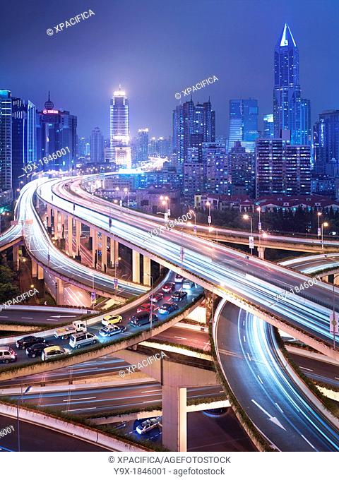 Automobiles in congested onramp traffic at a six-level stack interchange highway in Puxi, Shanghai, China