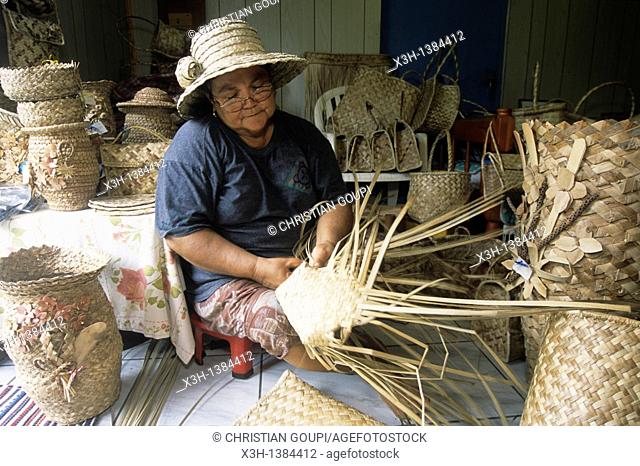 woman making basketworks with Common screwpine's leaves Reunion island, overseas departement of France, Indian Ocean
