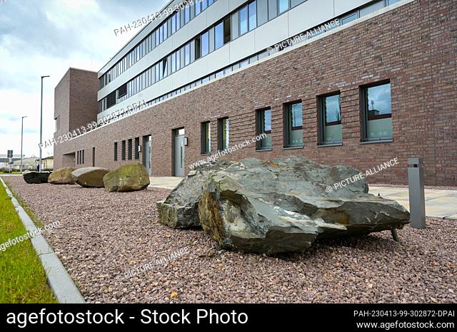 13 April 2023, Saxony-Anhalt, Halle (Saale): Erratic blocks of various stone materials lie in front of the new building of the State Office for Geology and...