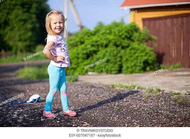 Little girl walking outdoor, having fun and laughting