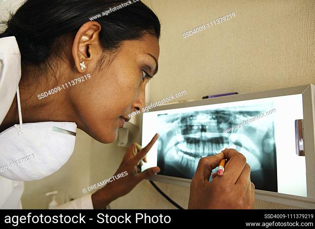 Female dentist examining patients' teeth