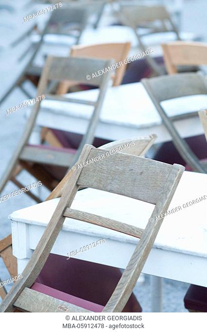 Tables and wooden chairs in a row