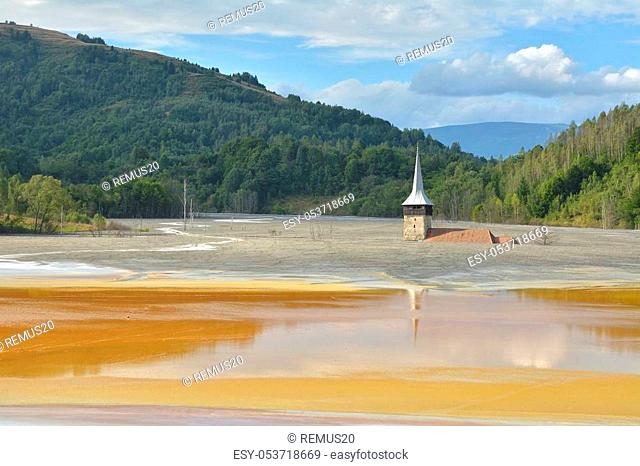 Flooded and abandoned church in the middle of a contaminated lake