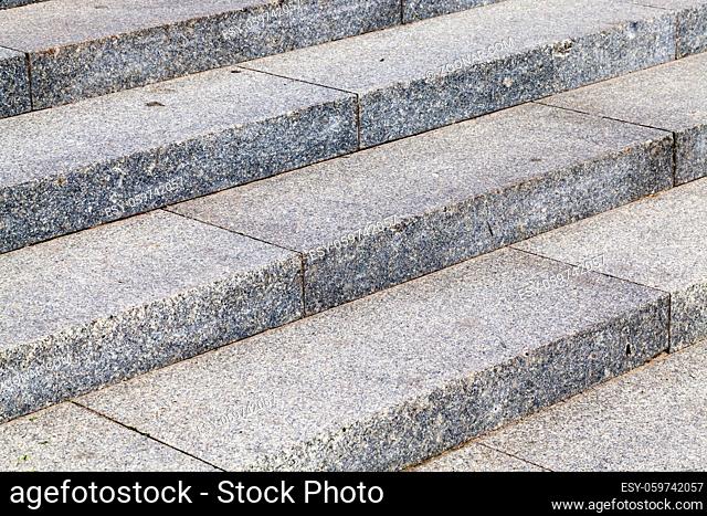 Steps on the stairs in the park, made of concrete slabs with pebbles. photo close-up, view at an angle