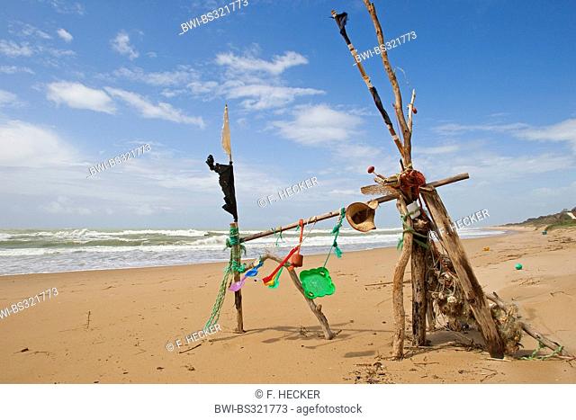 mobile at the sand beach made of flotsam and left toys and litter, Italy, Sicilia
