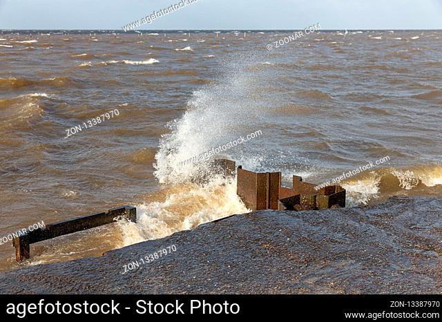 Dutch breakwater in IJsselmeer Flevoland with breaking wave in heavy storm