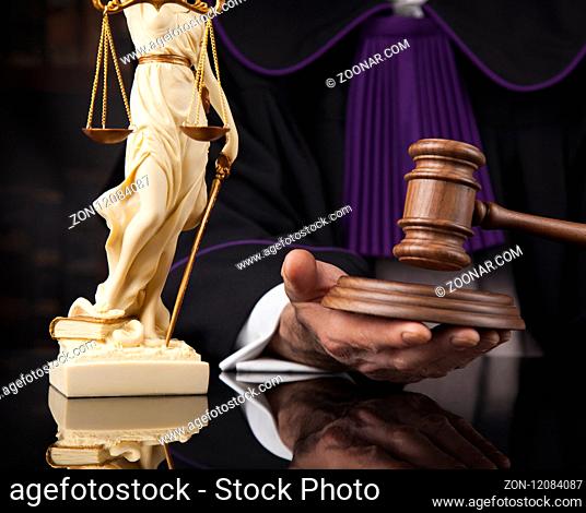 law theme, mallet of the judge, wooden desk, scales of justice