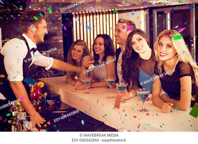 Composite image of attractive friends being served cocktails