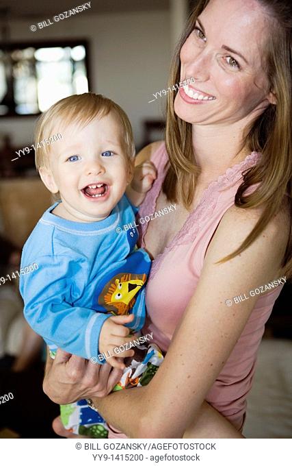 Young mother holding smiling baby boy - Fort Lauderdale, Florida USA