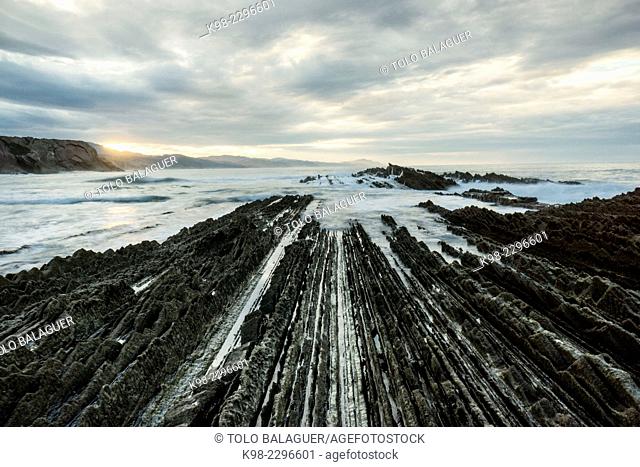 Spain, Euzkadi, Guipuzcoa, Zumaia, Beach and rocks showing rock formation Flysch during retreating tide