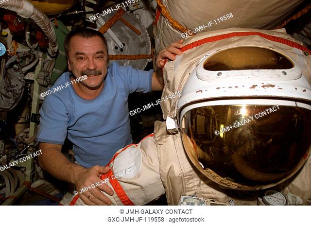 Cosmonaut Mikhail Tyurin, Expedition 14 flight engineer representing Russia's Federal Space Agency, photographed near a Russian Orlan spacesuit in the Pirs...