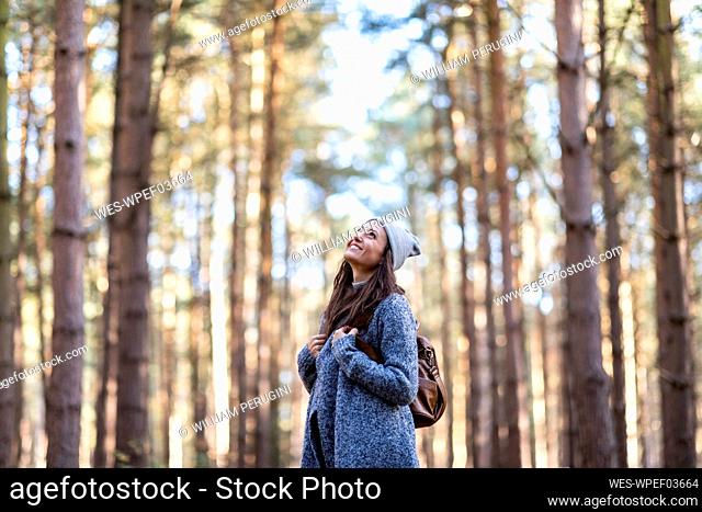 Smiling female hiker exploring in Cannock Chase woodland