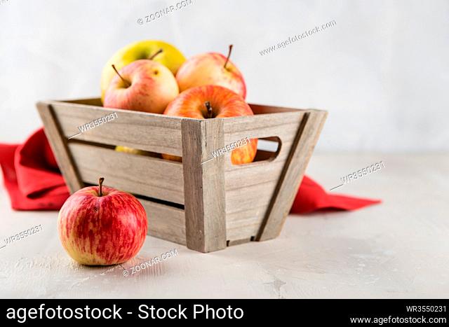 Decorative wooden box with red and green ripe apples