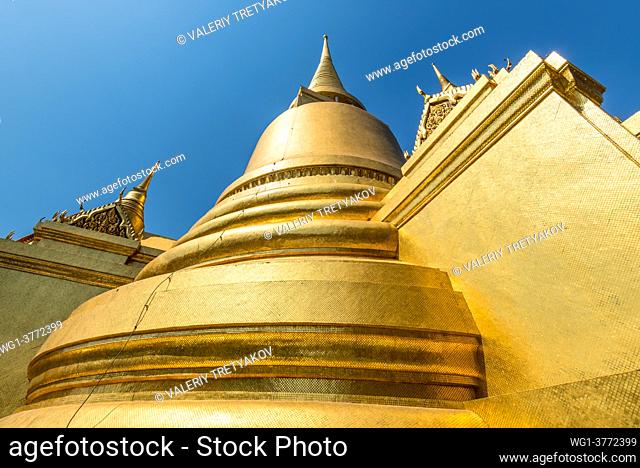 Bangkok, Thailand - December 7, 2019: Gold plated mosaic on stupa, chedi close up, Golden pagoda at Temple of the Emerald Buddha, Grand Palace in Bangkok