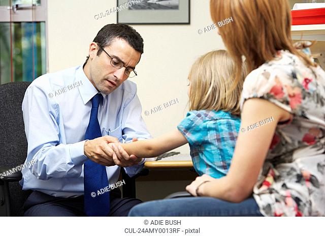 Doctor examining young girl