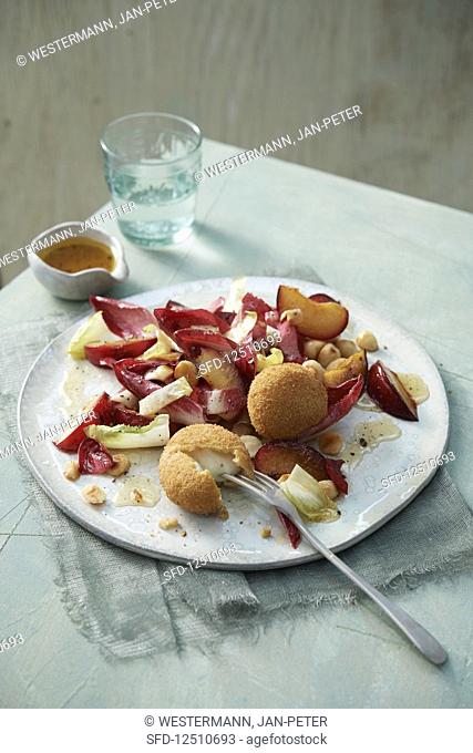 Red and yellow chicory salad with baked mozzarella, red plums and nut dressing