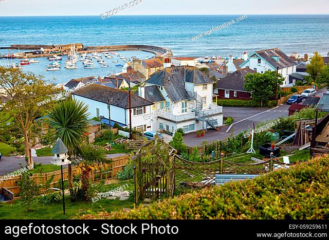 The beautiful view from the high Cobb road to the famous man-made Cobb harbor of Lyme Regis with the docked boats and yachts. West Dorset. England