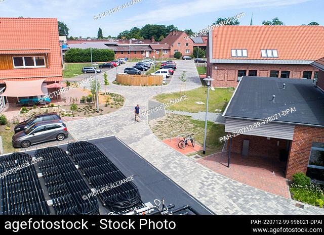 12 July 2022, Lower Saxony, Wahrenholz: Aerial view of the new village center of the municipality of Wahrenholz. With the project ""Ecological heating concept...