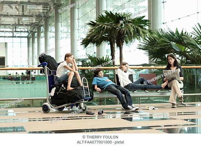 Family waiting in airport terminal
