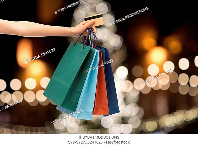 shopping bags and credit card in hand at christmas
