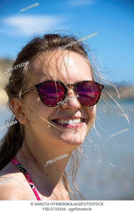 young woman on vacation at the beach, here Salema beach, Algarve, Portugal, Europe