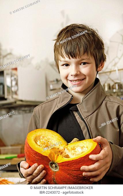 Boy holding a hokkaido pumpkin