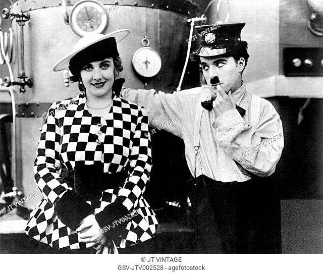 Edna Purviance and Charlie Chaplin on-set of the Film, The Fireman, 1916