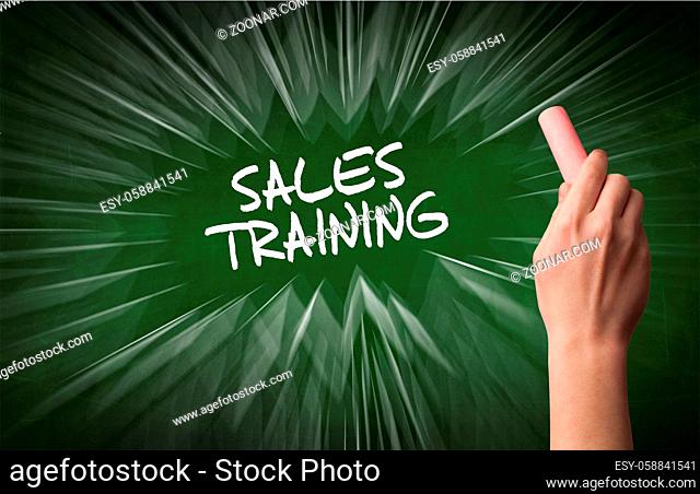 Hand drawing SALES TRAINING inscription with white chalk on blackboard, online shopping concept