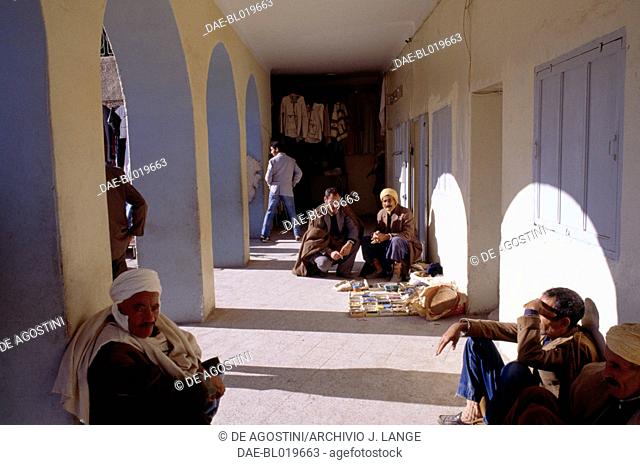 Men sitting under a portico, Bou Saada, Algeria