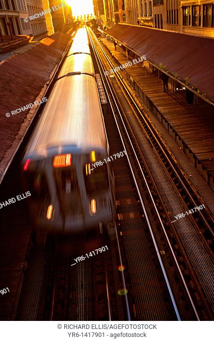 Sunrise illuminates a train in the Chicago rapid transit system known as the'L' in Chicago, IL, USA