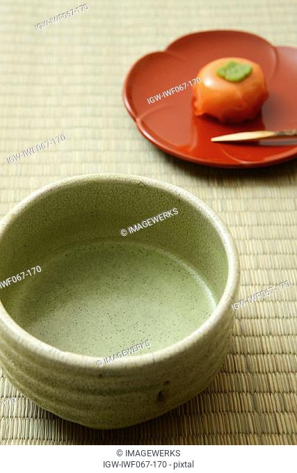 Matcha Japanese powdered green tea on tatami, close-up