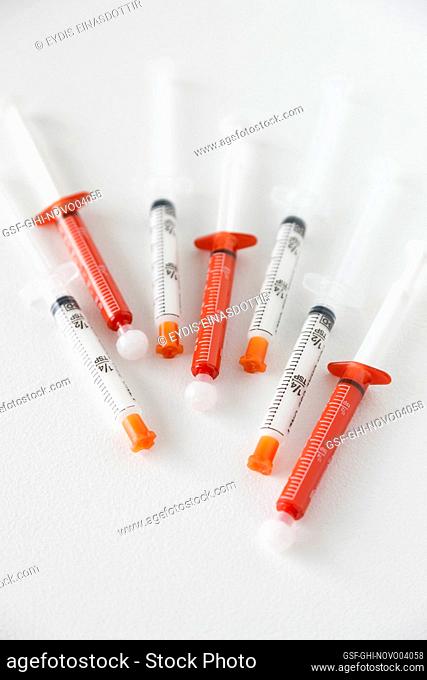 7 syringes on white background