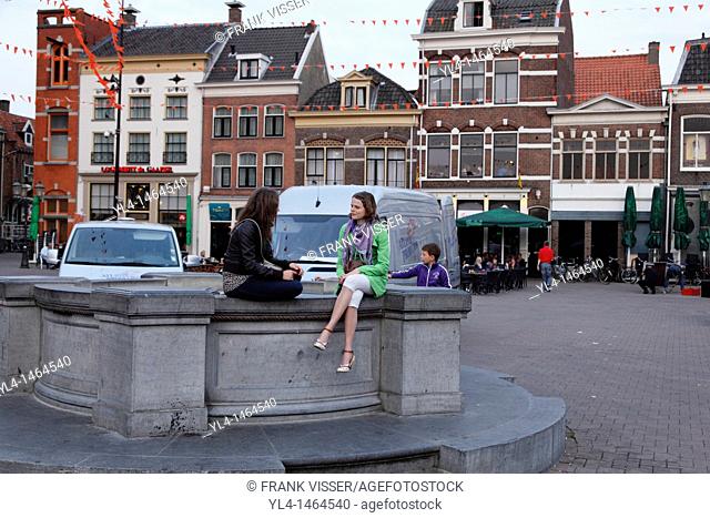Girls talking on square De Hof in the city centre of Amersfoort, Netherlands