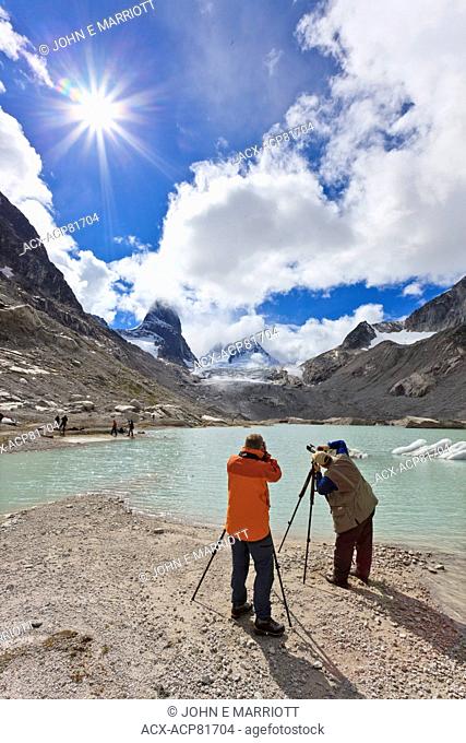 Landscape photographers taking pictures of the Vowell Glacier and Howser Tower in the Bugaboo Mountains, BC, Canada