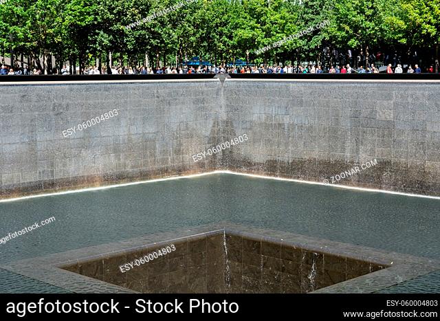 New York, United States of America - September 19, 2019: People standing at the north pool of the World Trade Center Ground Zero Memorial in Lower Manhattan