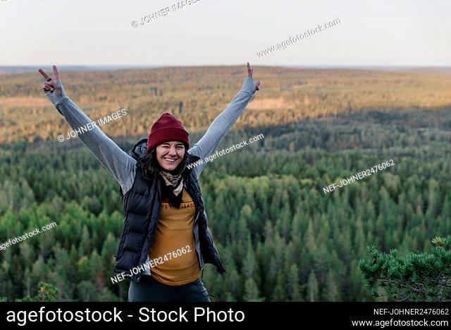 Happy hiker showing peace sign
