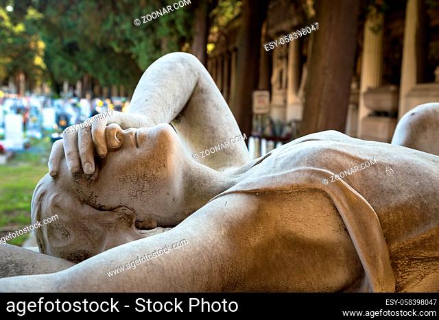 GENOA, ITALY - June 2020: antique statue of angel (1910, marble) in a Christian Catholic cemetery - Italy
