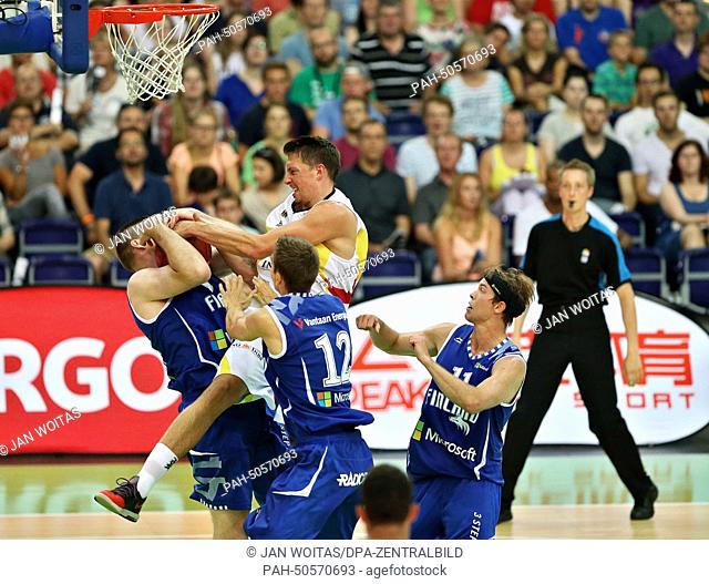 Germany's Danilo Barthel (C) and Finland's (L-R) Antti Nikkilae, Samuel Haanpaeae and Petteri Koponen during basketball match between Germany and Finland in the...