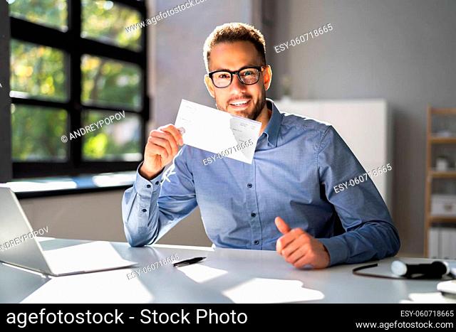 Holding Paycheck Or Payroll Check Or Insurance Cheque In Hand