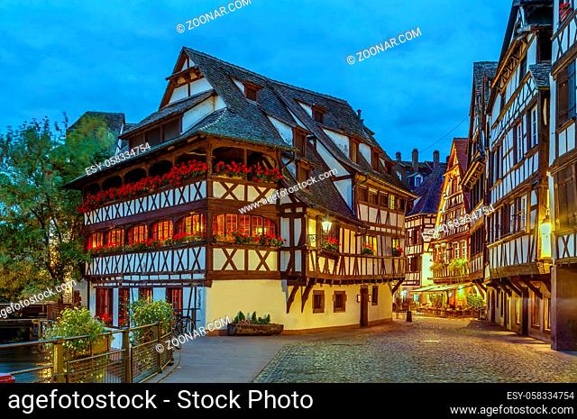 Street with historical half-timbered houses in Petite France district with Maison des Tanneurs (tanners house), Strasbourg, France. Evening