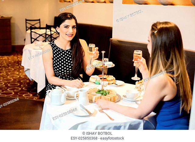 Two women conversing and enjoying dine