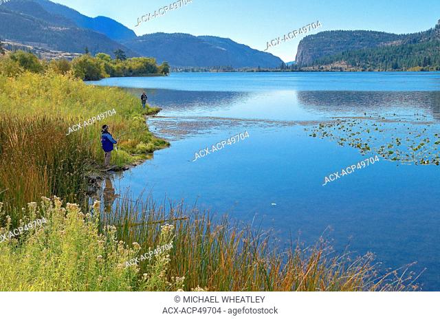 Man and woman fish at Vaseux Lake, Okanagan Region, British Columbia, Canada