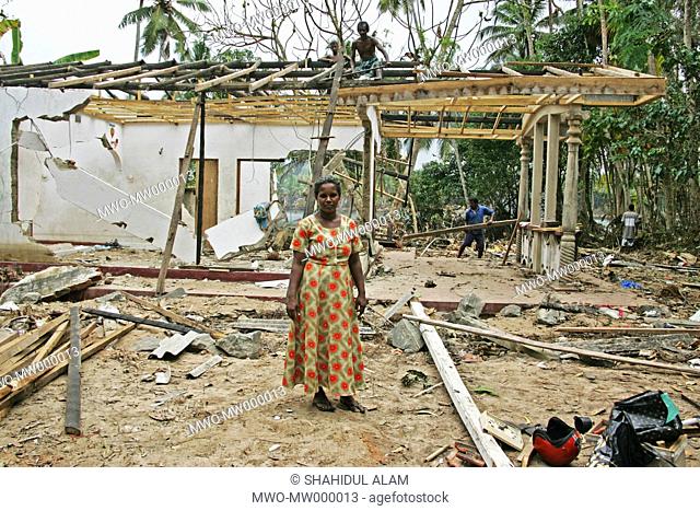 A woman A G Wijita stands amidst the ruins of her home that they are rebuilding The house stood near the lagoon in Hikkaduwa where countless dead bodies were...